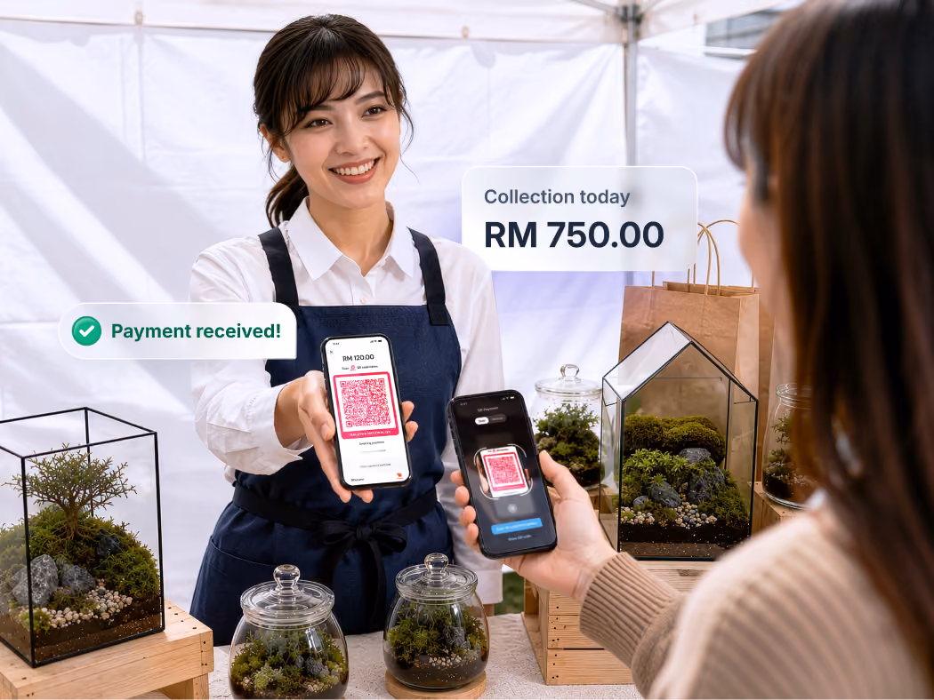 A seller at pop-up market showing her phone displaying QR to receive payments from customer.