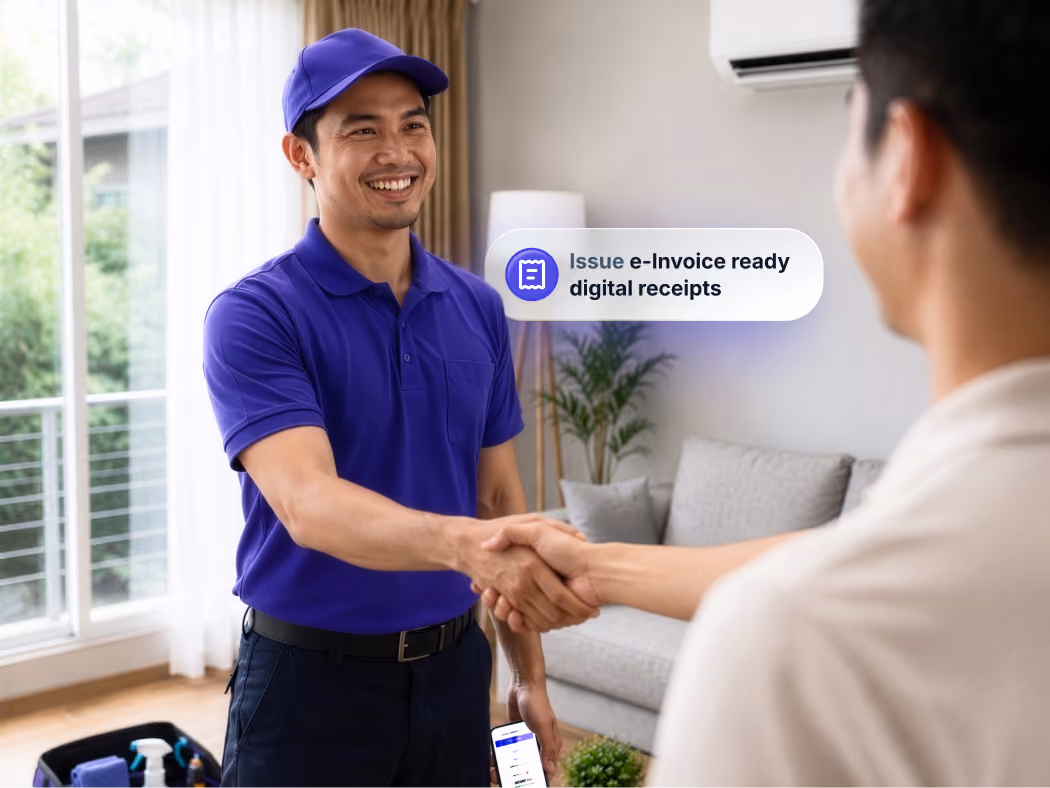 A technician shakes hand with a customer in their homes after completing a job.