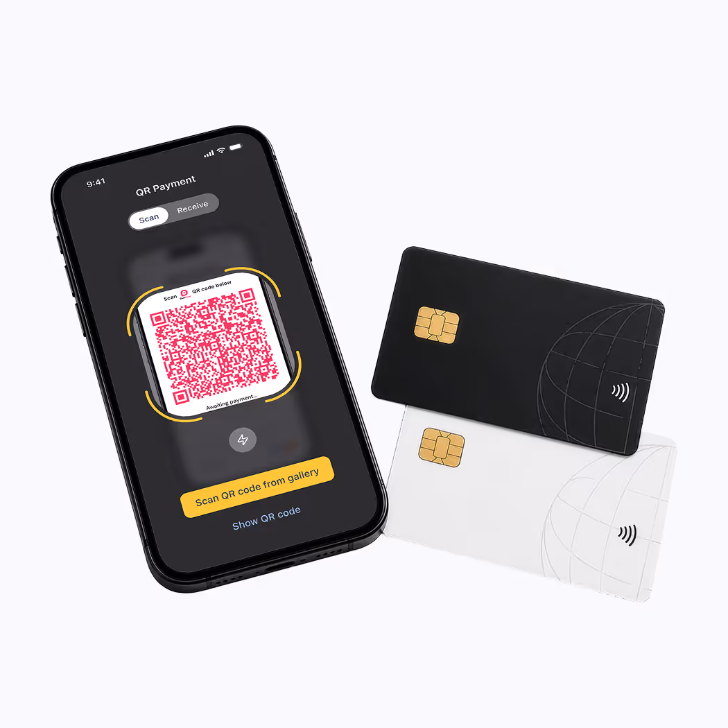 Smartphone displaying QR payment screen with two payment cards, one black and one white, nearby.