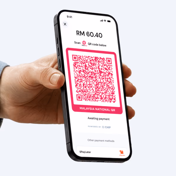 Hand holding smartphone displaying RM 60.40 payment QR code awaiting payment on screen.